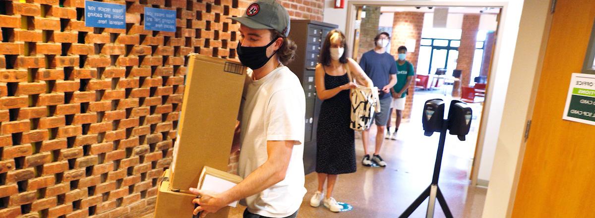 Student collecting package at Skidmore Post Office